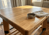 Applying food-safe oil to an end-grain butcher block kitchen island at the bench