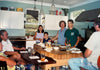 Family seated around Paul Diamond's first chef's island in a home kitchen