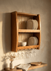 Wall-mounted plate rack displaying plates in warm evening kitchen light