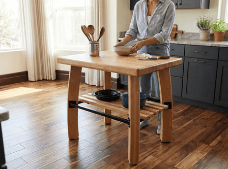 Person preparing food at a handmade solid wood kitchen island