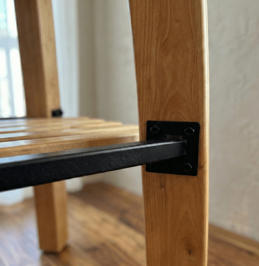 Wooden chair with metal armrest detail on a blurred background